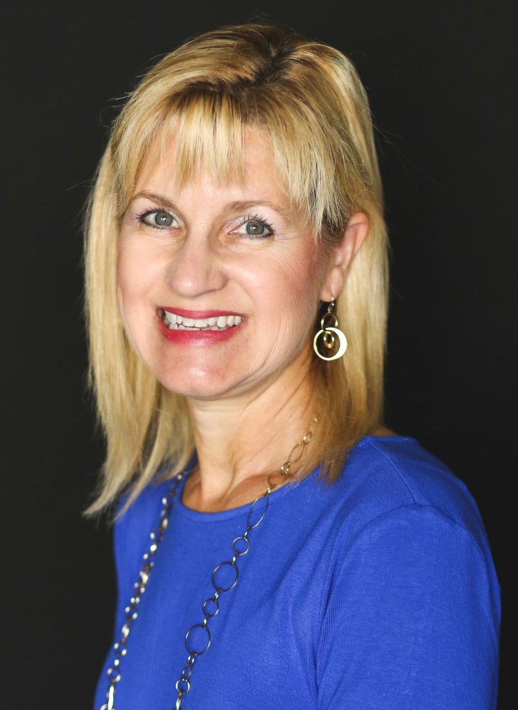 Headshot of blond, smiling professional organizer Mary Ann Mueth.